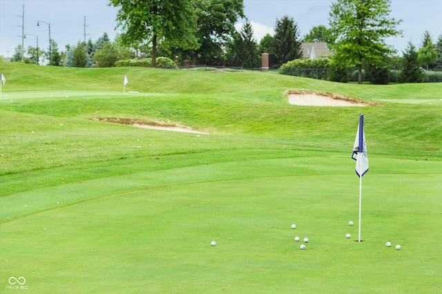 view of home's community featuring a yard and golf course view