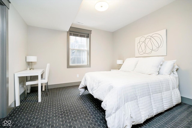 bedroom with dark carpet, baseboards, and visible vents
