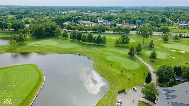 drone / aerial view featuring view of golf course and a water view