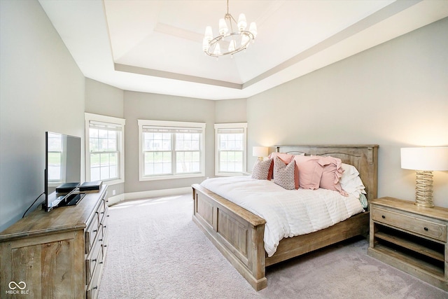 bedroom with a raised ceiling, light carpet, and an inviting chandelier