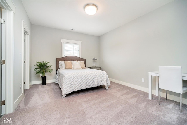 carpeted bedroom featuring baseboards and visible vents