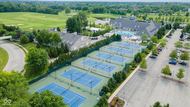 birds eye view of property with view of golf course and a water view