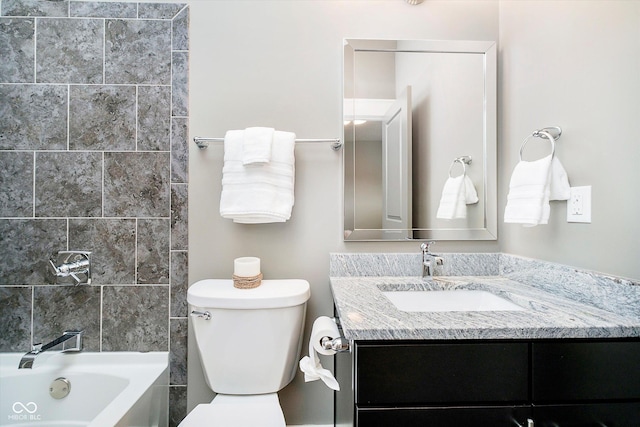 bathroom featuring bathtub / shower combination, vanity, and toilet