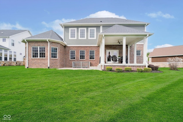 back of property featuring a patio area, brick siding, a ceiling fan, and a lawn