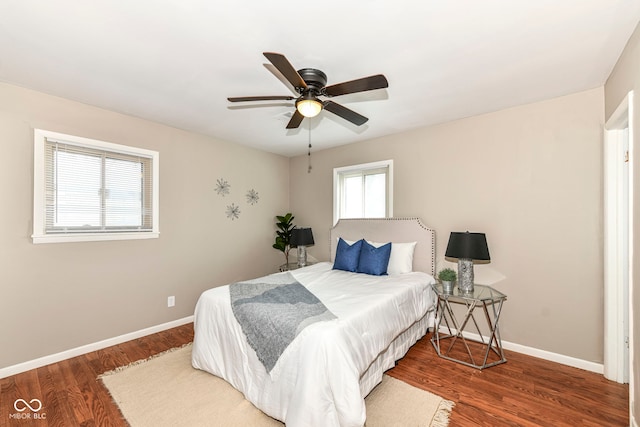 bedroom with baseboards, ceiling fan, and wood finished floors