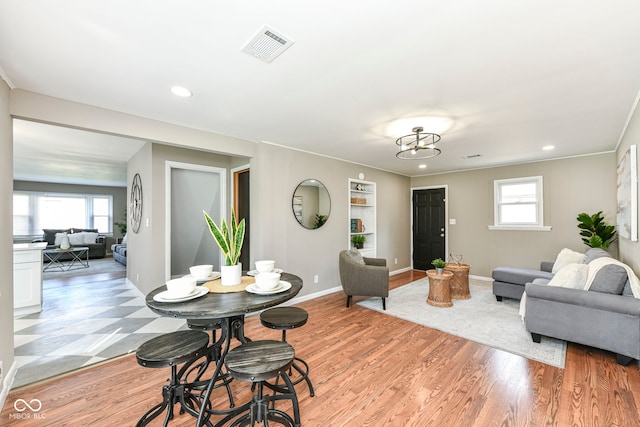 living area featuring a healthy amount of sunlight, baseboards, and visible vents