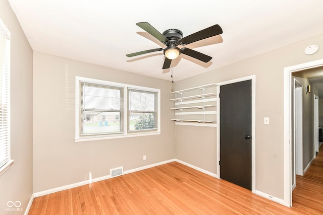 unfurnished bedroom with ceiling fan, light wood finished floors, baseboards, and visible vents