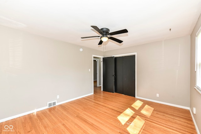 unfurnished bedroom featuring visible vents, baseboards, and light wood finished floors