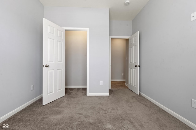 unfurnished bedroom with baseboards and carpet floors