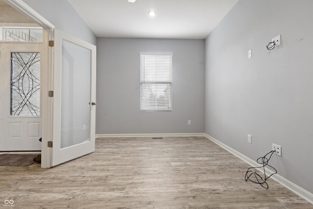 entryway with french doors, baseboards, and wood finished floors