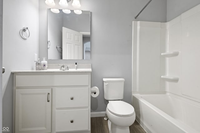full bathroom with vanity, toilet, baseboards, bathing tub / shower combination, and wood finished floors