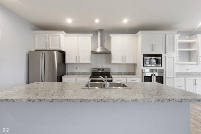 kitchen with wall chimney range hood, white cabinetry, open shelves, and stainless steel appliances