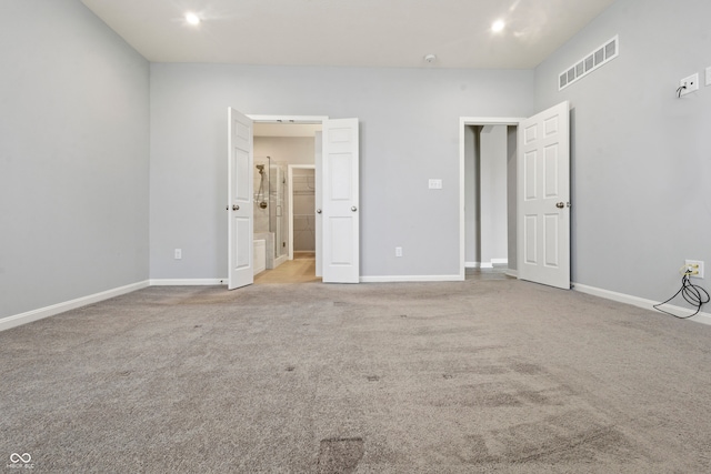 unfurnished bedroom with baseboards, visible vents, and carpet