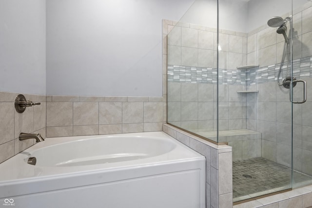 full bathroom featuring a garden tub and a shower stall