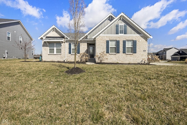 craftsman inspired home featuring board and batten siding, brick siding, and a front yard