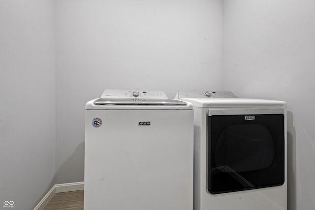 laundry room with independent washer and dryer, baseboards, and laundry area