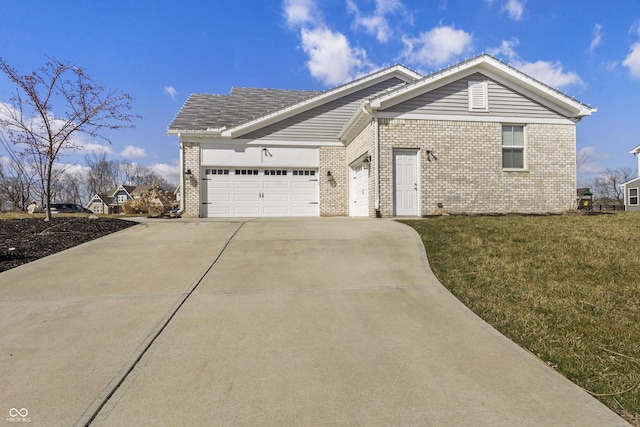 single story home featuring an attached garage, brick siding, a front lawn, and concrete driveway