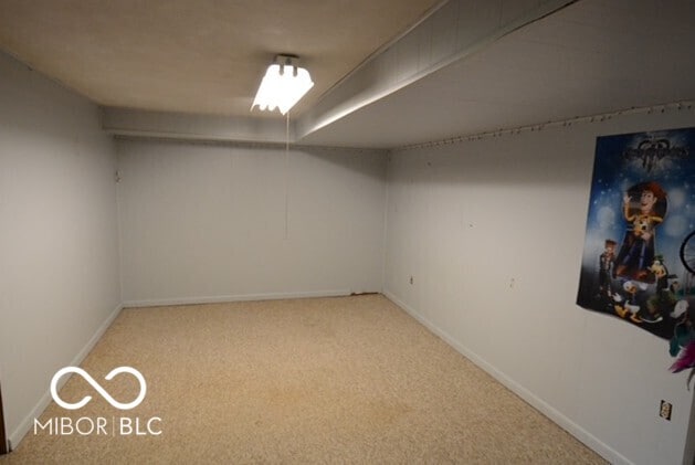 finished basement with baseboards and carpet flooring