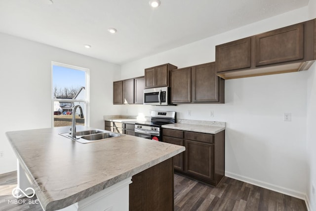 1924 White Oak Dr, Shelbyville, IN 46176 - kitchen with stainless steel appliances, dark wood-style floors, a sink, baseboards, and dark brown cabinetry