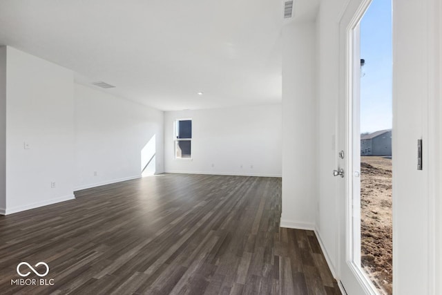 1924 White Oak Dr, Shelbyville, IN 46176 - unfurnished room with baseboards, visible vents, a wealth of natural light, and dark wood-style floors