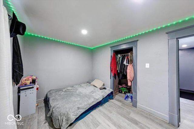 215 S Warman Ave, Indianapolis, IN 46222 - bedroom featuring baseboards and wood finished floors