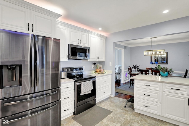 6820 W Forest Brook Dr, Fountaintown, IN 46130 - kitchen featuring appliances with stainless steel finishes, light countertops, white cabinets, decorative light fixtures, and recessed lighting