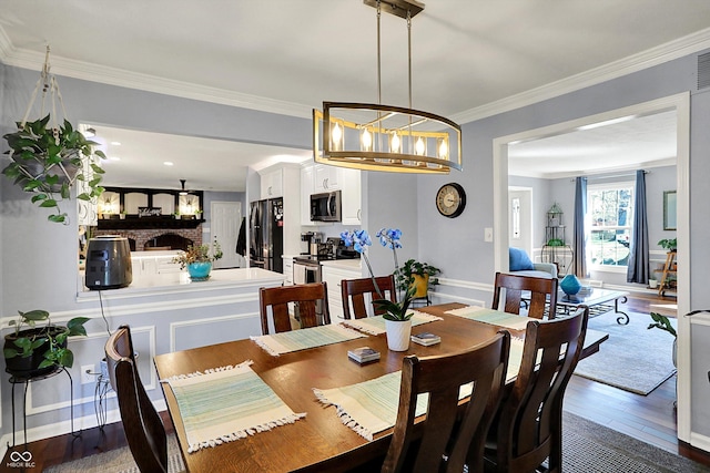 6820 W Forest Brook Dr, Fountaintown, IN 46130 - dining area with dark wood-style floors, baseboards, and ornamental molding