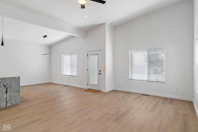 2362 English Ave, Indianapolis, IN 46201 - unfurnished living room with light wood finished floors, vaulted ceiling with beams, ceiling fan, and baseboards
