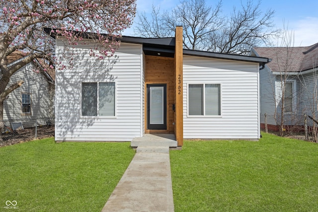 2362 English Ave, Indianapolis, IN 46201 - view of front of home with a chimney, fence, and a front lawn
