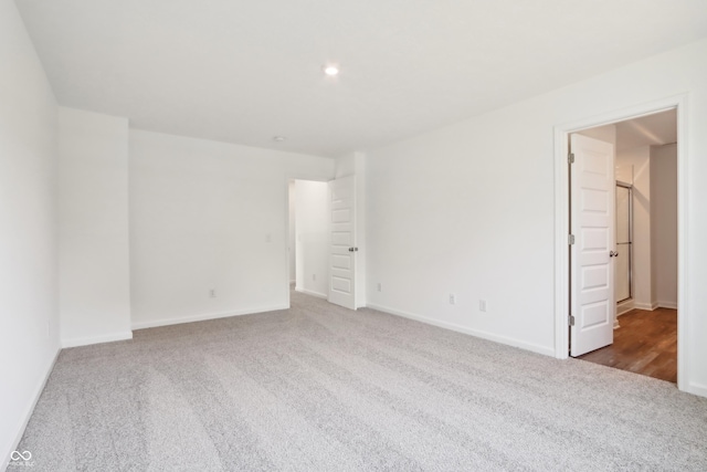 empty room with baseboards, recessed lighting, and carpet flooring