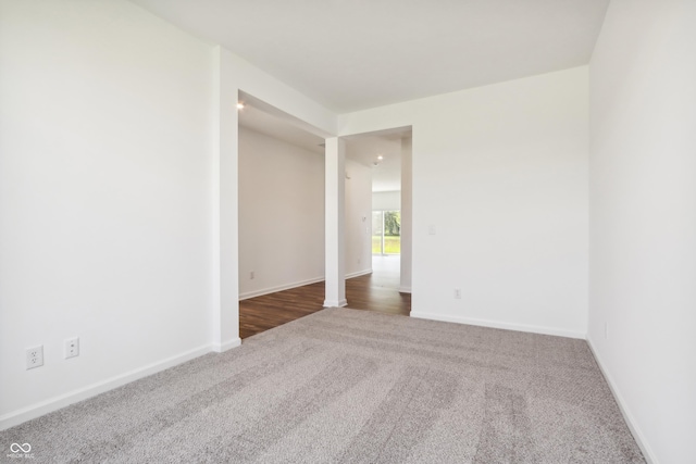 spare room featuring carpet floors and baseboards