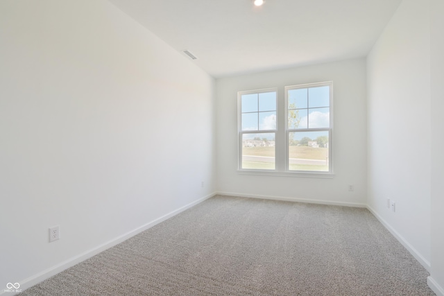 spare room with recessed lighting, baseboards, light colored carpet, and visible vents