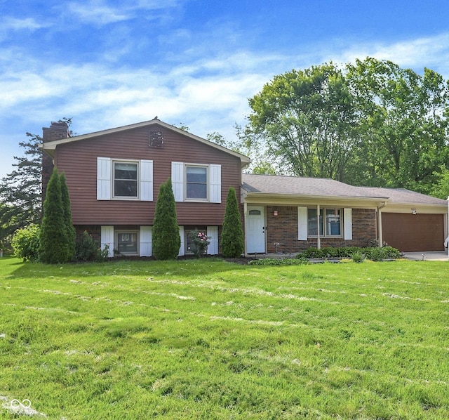 8315 San Marcos Cir, Indianapolis, IN 46256 - tri-level home with a chimney, a front yard, and a garage