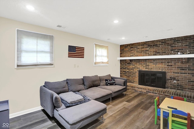 8315 San Marcos Cir, Indianapolis, IN 46256 - living room with wood finished floors, a brick fireplace, and recessed lighting