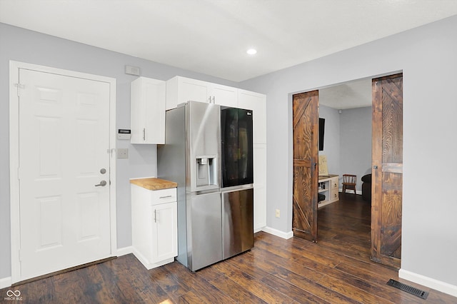 8315 San Marcos Cir, Indianapolis, IN 46256 - kitchen with stainless steel refrigerator with ice dispenser, dark wood-style floors, white cabinets, recessed lighting, and light countertops