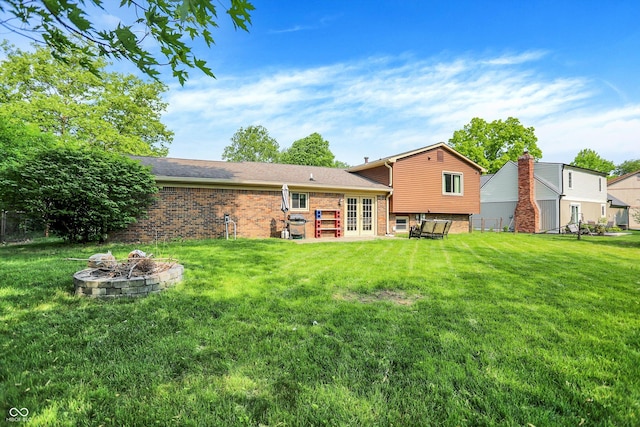 8315 San Marcos Cir, Indianapolis, IN 46256 - back of house featuring a fire pit, french doors, brick siding, and a yard