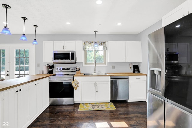 8315 San Marcos Cir, Indianapolis, IN 46256 - kitchen featuring appliances with stainless steel finishes, butcher block counters, healthy amount of natural light, dark wood-style flooring, and recessed lighting