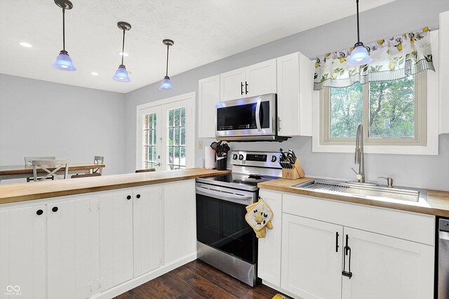 8315 San Marcos Cir, Indianapolis, IN 46256 - kitchen with appliances with stainless steel finishes, plenty of natural light, dark wood-style floors, decorative light fixtures, and recessed lighting