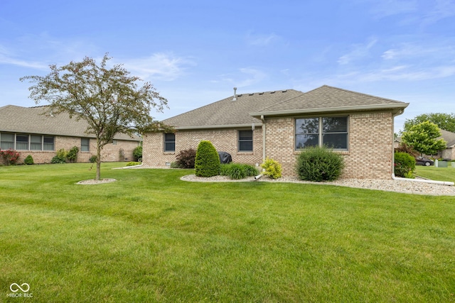 1864 Holiday Pines Dr, Brownsburg, IN 46112 - view of front of house with a front yard, a shingled roof, and brick siding