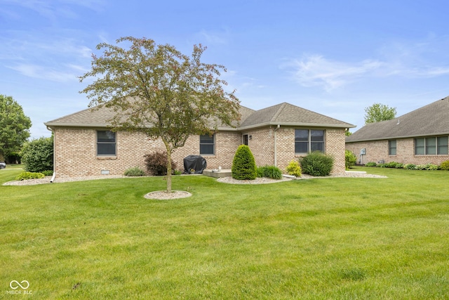 1864 Holiday Pines Dr, Brownsburg, IN 46112 - view of front of home featuring a front yard, brick siding, and roof with shingles