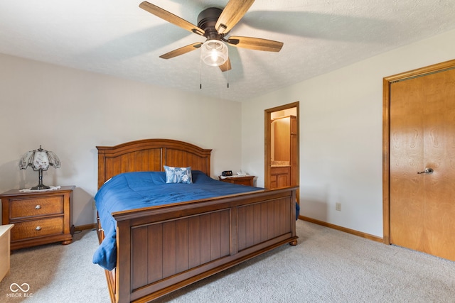 1864 Holiday Pines Dr, Brownsburg, IN 46112 - bedroom with light carpet, baseboards, ensuite bath, and ceiling fan