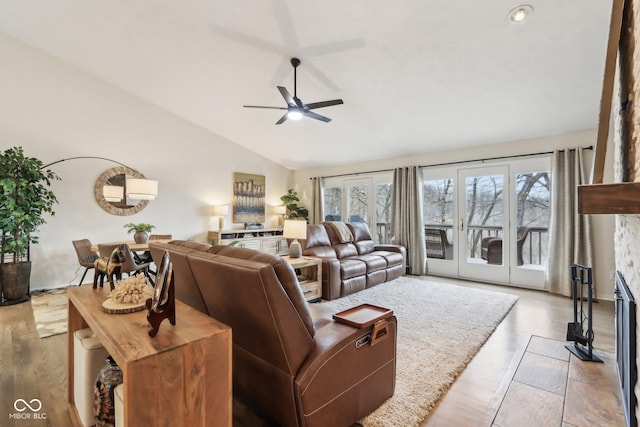 living area featuring a wealth of natural light, ceiling fan, wood finished floors, and lofted ceiling