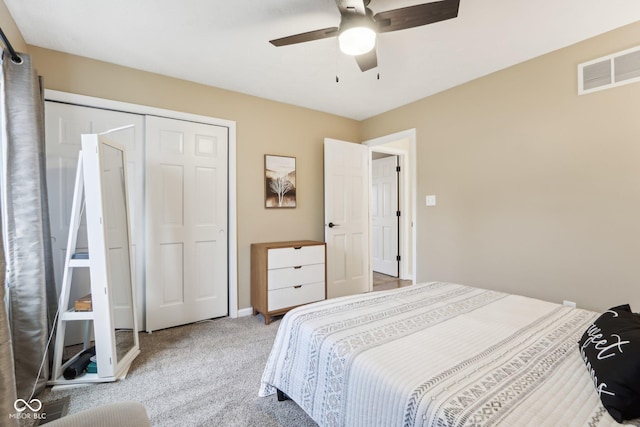 carpeted bedroom featuring visible vents, ceiling fan, a closet, and baseboards