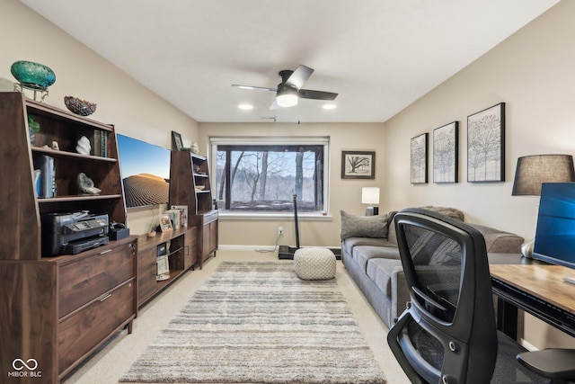 living area featuring ceiling fan, light carpet, and baseboards