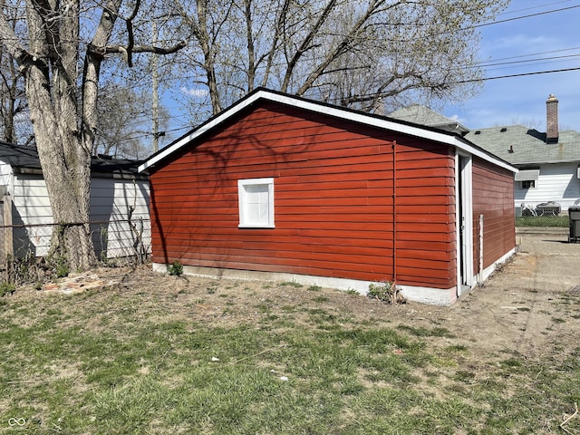 view of home's exterior with fence and a lawn