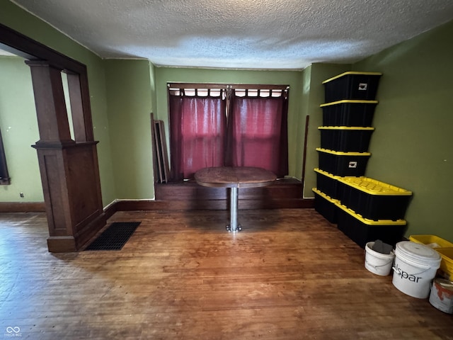 3179 W 400 N, Fairland, IN 46126 - dining space with wood finished floors, a textured ceiling, ornate columns, and baseboards