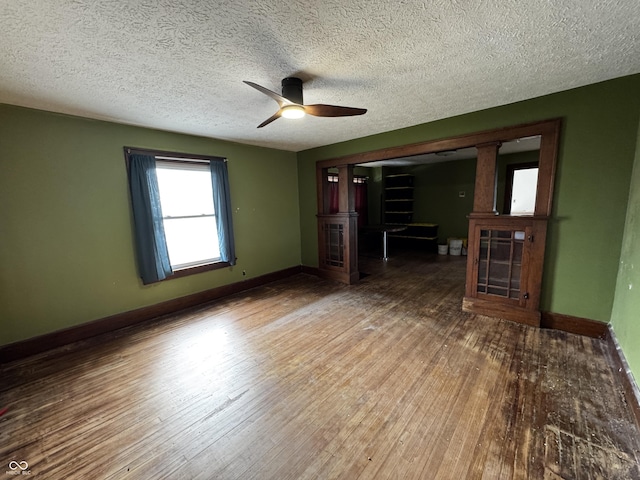 3179 W 400 N, Fairland, IN 46126 - unfurnished living room with a fireplace, ceiling fan, wood finished floors, baseboards, and a textured ceiling
