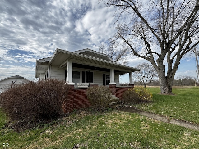 3179 W 400 N, Fairland, IN 46126 - view of front of home featuring covered porch, a front yard, and brick siding