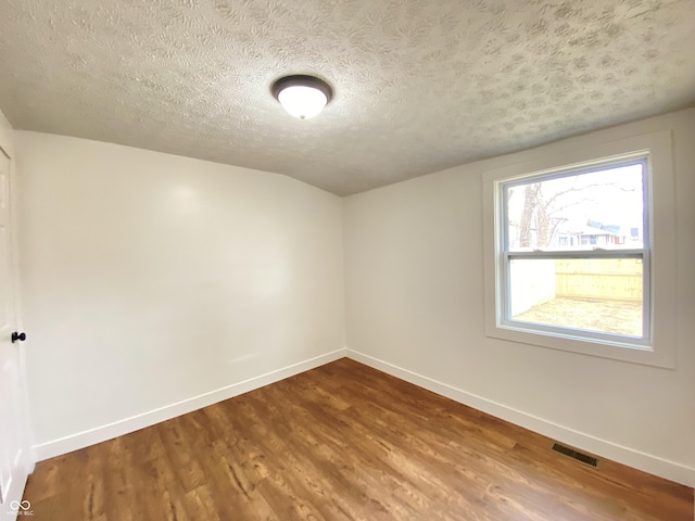 1518 Lawton Ave, Indianapolis, IN 46203 - spare room featuring wood finished floors and a textured ceiling