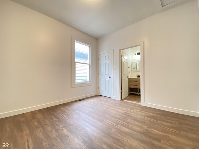 1518 Lawton Ave, Indianapolis, IN 46203 - unfurnished bedroom with dark wood-style flooring and connected bathroom